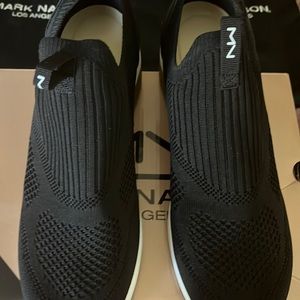 Women’s Black wedge sneakers with white and gold heel.